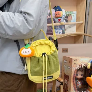 Cute yellow and green plaid bucket crossbody bag with plush pumpkin pendant, casual bag.