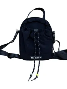 Black fabric drawstring bucket bag, casual outdoor messenger bag with adjustable strap and beads.