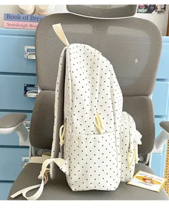 Cute white polka dot canvas school backpack with yellow straps and delicate lace trim.