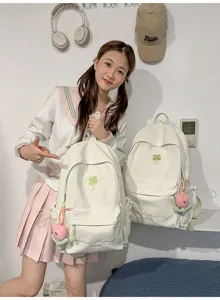 White canvas backpack with green clover embroidery, casual cute school bag for daily use.