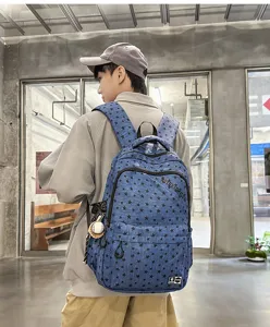 Vintage street style blue star pattern backpack detail view, multi-compartment student school bag.