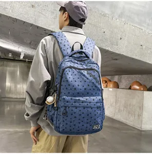 Detailed close-up of blue denim star print backpack, ideal for students and daily casual use.