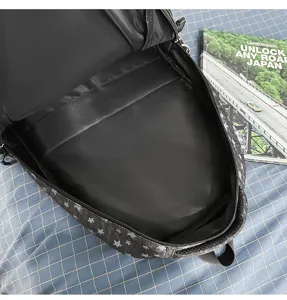 Detailed view of the black star print backpack interior, showing spacious multi-compartment storage.