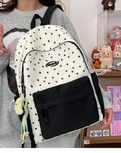 Detail view of the Japanese style star print canvas backpack with large front pocket and cute charms.