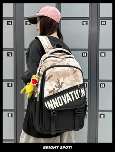 Sac à dos utilitaire camouflage élégant avec blocage de couleur et pendentif dinosaure pour tous.
