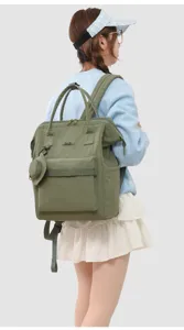 Stylish green travel backpack with top handles and front pocket, perfect for mothers.