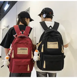 Fashion multi-compartment casual canvas student backpack with cute duck pendant style.