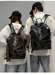 Detailed view of vintage multi-pocket leather backpacks for couples, outdoor street style.