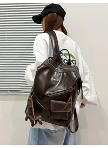 Retro motorcycle style dark brown leather backpack detail showcasing multi-pocket and casual look.