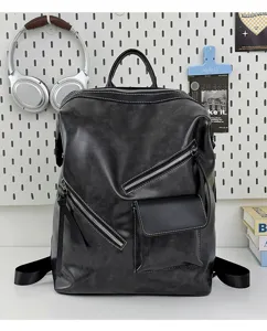 Detail view of the stylish black leather backpack showcasing contrast white stitching and metal zippers.