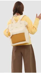 Detailed back view of casual canvas backpack with wide opening and matching pouch.