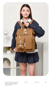 Detailed view of the Japanese minimalist solid color multi-pocket mommy backpack in brown canvas.