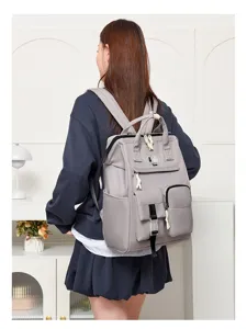 Detailed view of grey mommy backpack featuring multi-pocket design and comfortable shoulder straps.