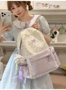 Detail shot of sweet star print and purple plaid backpack with cute plush cloud pendant.