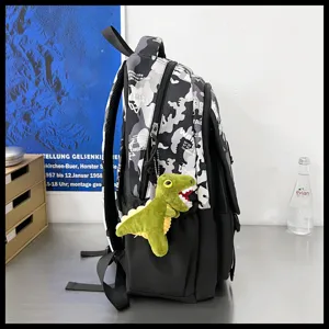 Superbe sac à dos camouflage avec pendentif dinosaure vert pour l'école et les loisirs.