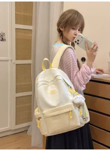 Close-up detail of the sweet style star patterned backpack with plaid pocket and cute plush pendant.