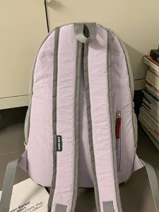 Lightweight purple casual backpack with gray straps and zipper pocket for daily outdoor travel.