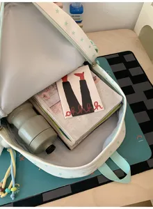 Detail view of cute star pattern pastel school backpack showing spacious interior.