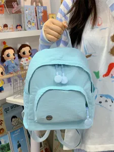 Gentle minimalist mini backpack for women, cute light blue schoolbag with smiley zipper.