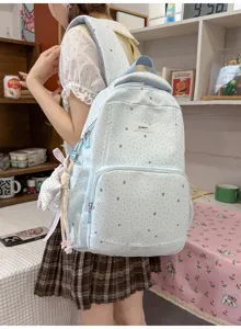 Light blue star print backpack detail, cute lace trim and hanging charms for students.