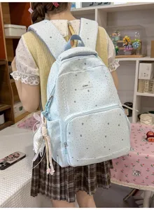 Details of light blue star print school backpack with cute lace trim, perfect for daily travel use.