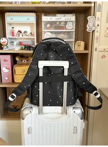 Detailed view of the black star print backpack luggage strap feature showing back design clearly.
