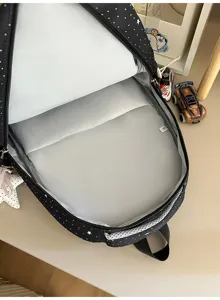 Detailed view of black star pattern backpack interior, spacious storage compartment for daily use.