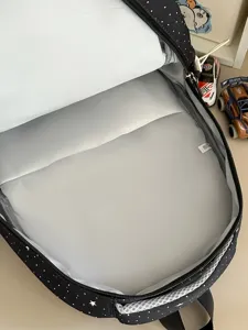 Black starry dot school backpack open view showing spacious interior lining and clean design.
