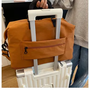 Brown travel duffel bag with luggage sleeve, large capacity canvas weekender bag for travel.