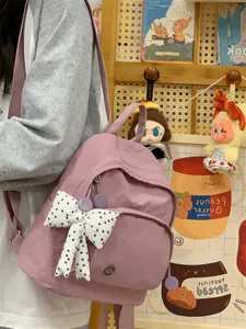 Detailed view of the cute mini backpack in pastel purple with a sweet polka dot bow accent.