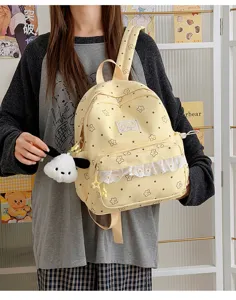 Cute Japanese Lolita style canvas backpack with lace ruffles, star pattern, and puppy pendant.