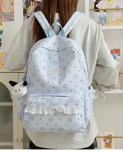 Light blue cute backpack detail showing star print, white lace ruffle and puppy charm.
