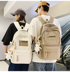 Canvas casual student backpack with multi-compartments, cute duck pendant and color block design.