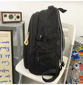Black tooling backpack with multi compartments and side straps for daily travel and school use.
