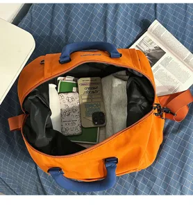 Borsa da viaggio arancione da donna, grande borsa sportiva fitness con manici e tracolla blu.