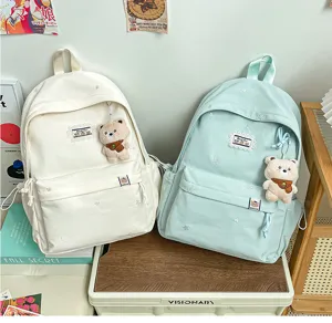 Sac à dos esthétique style japonais mignon avec pendentif en peluche pour école et voyage.