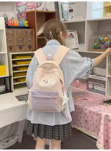 Details view of Korean style canvas backpack with multi-pocket storage and cute pastel color block.