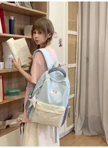 Light blue beige canvas backpack cute school bag casual daypack for students traveling storage.