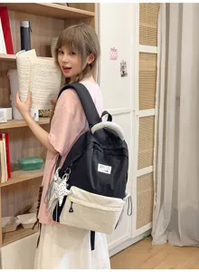 Korean style colorblock canvas backpack for school and casual travel, spacious storage design.