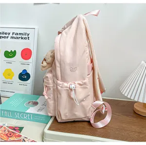 Sac à dos rose mignon pour fille style japonais avec pendentif ours et poche latérale pour école.