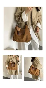 Detailed view of brown suede shoulder bag featuring a cute plush bear charm pendant.