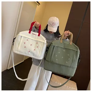 Grande borsa da viaggio in tela con ricamo di fiocco, ideale per fitness e viaggi quotidiani.