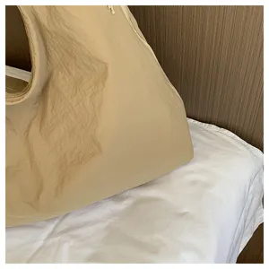 Detail view of Korean slouchy pleated shoulder bag, minimalist solid handbag for daily commute.