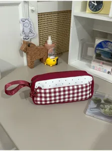 Aesthetic red plaid and polka dot pencil case with convenient handle for students.
