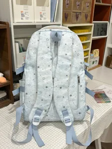 Light blue star print school backpack with adjustable straps and multiple pockets for daily use.