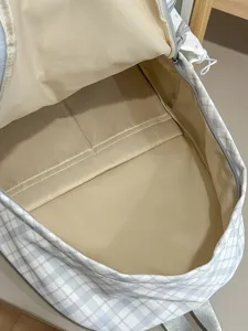 Japanese style sweet plaid school backpack with large capacity interior compartments.