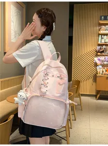 Pink ita backpack with transparent front pocket, star patterns and cute plush pendant for girls.
