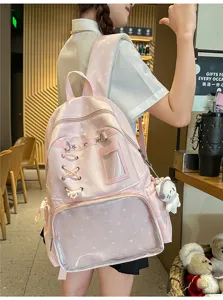 Pink star print Ita backpack with clear window, cute lace-up detail and plush doll charm.