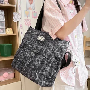 Detailed close-up showing the stylish starry tie-dye canvas shoulder bag in daily use.