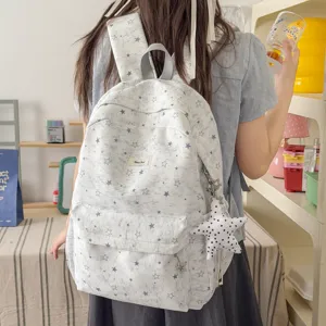 Detailed shot of a cute star printed canvas backpack with star pendant for daily use.